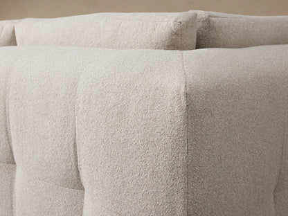Keegan Four Piece Sectional sofa, light beige textured fabric, L-shaped with chaise, on wood floor.