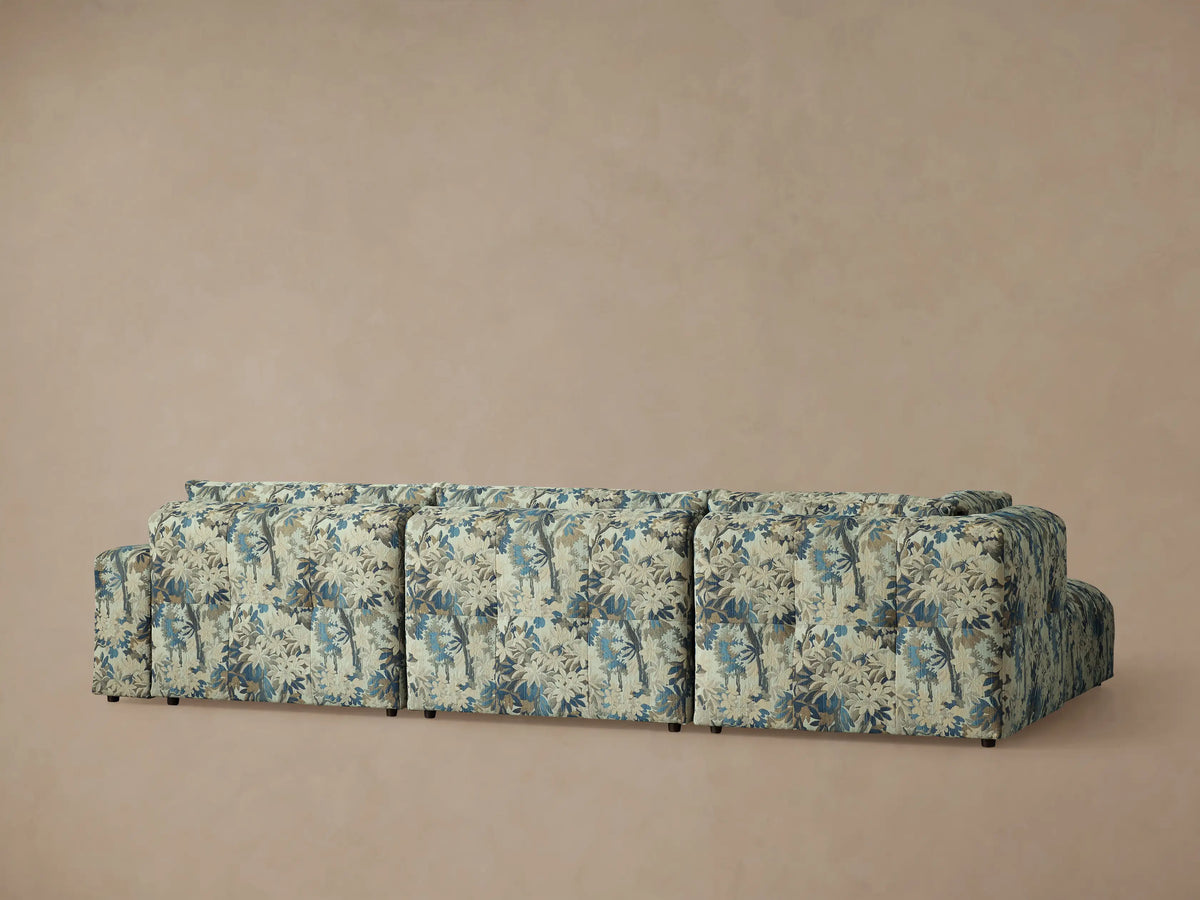 Close-up of Keegan Four Piece Sectional's blue, teal, beige, and brown floral upholstery on tufted cushions and backrests.
