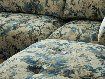 Keegan Four Piece Sectional with Ottoman, L-shaped, in blue, green, and beige tropical print fabric on wood floor.