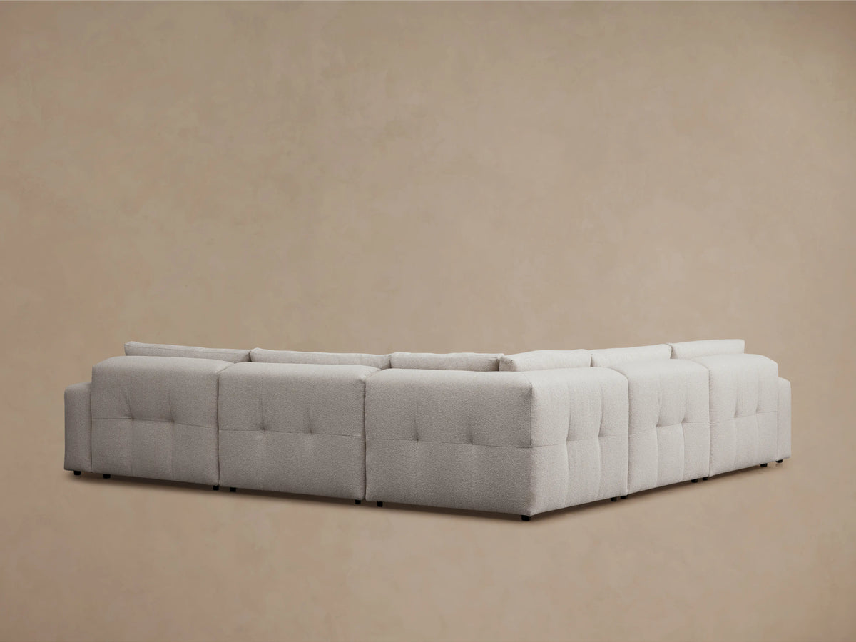 Keegan Five-Piece Corner Sectional in light gray fabric, showing close-up of the textured upholstery and plush cushions against a neutral background.