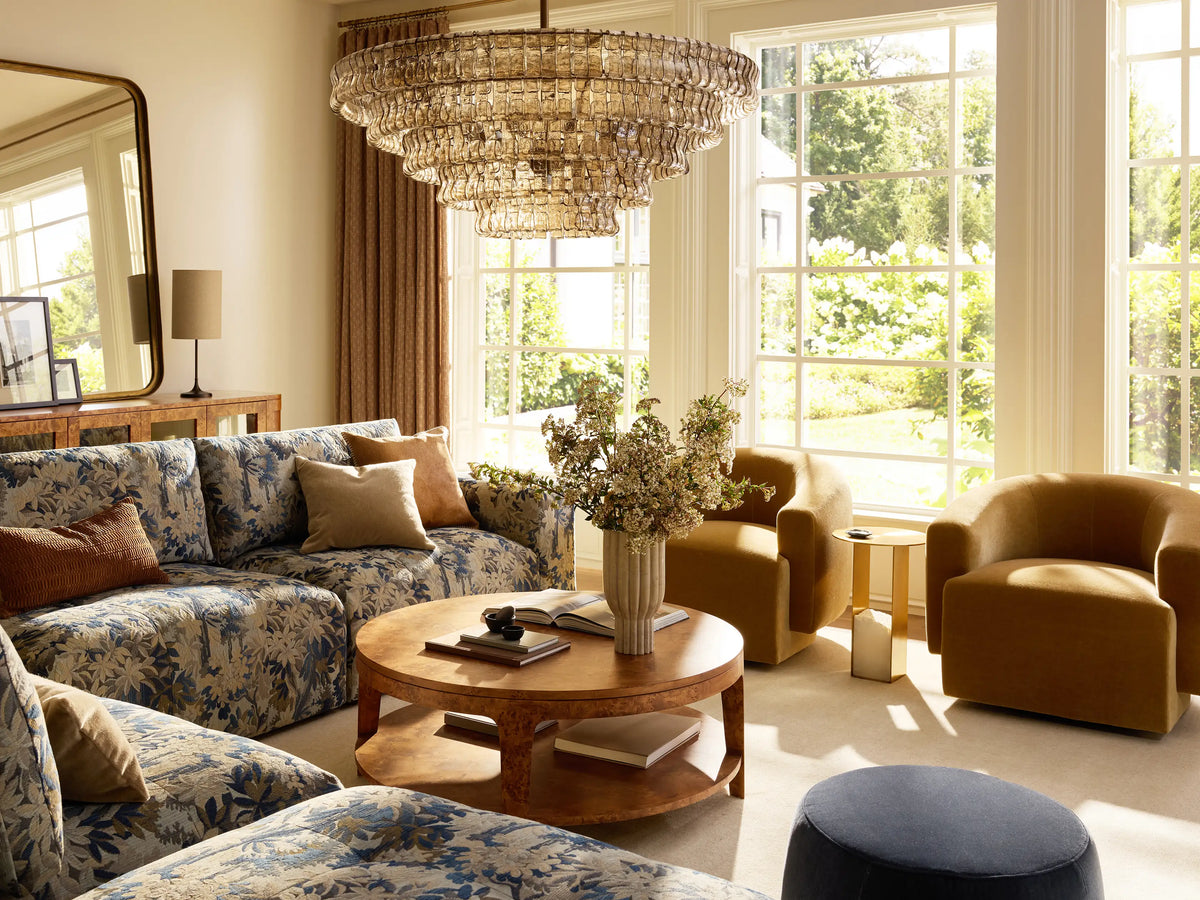 Keegan Five-Piece Sectional in L-shape, upholstered in blue, green, and brown leafy pattern, against a beige wall on a wood floor.
