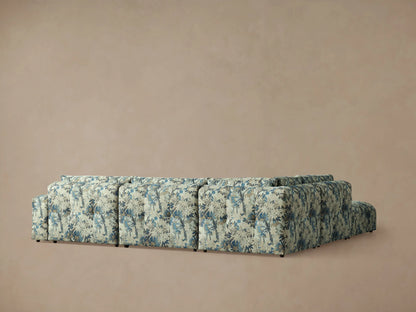Textured Keegan Five-Piece Sectional with blue, green, and tan botanical fabric, close-up of corner.