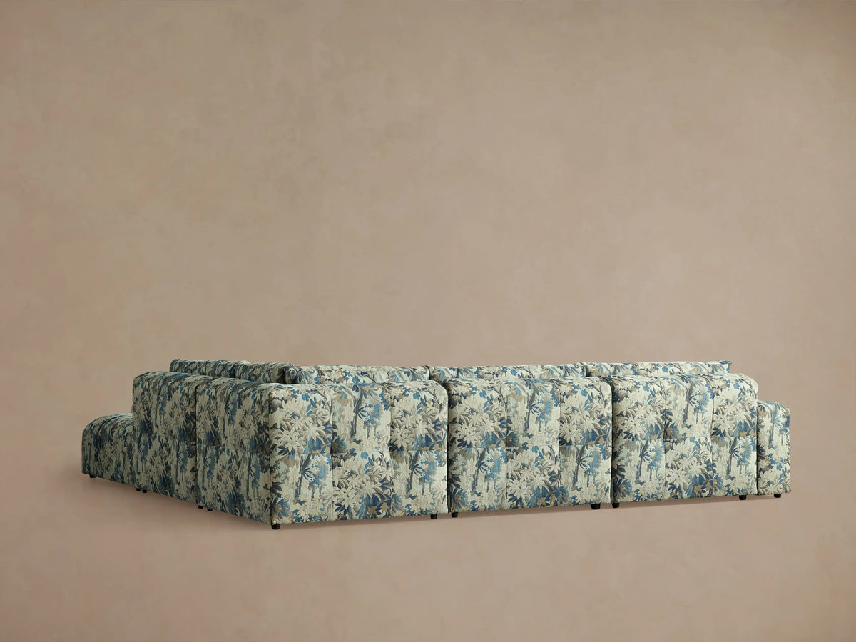 Keegan Five-Piece Sectional close-up. Blue, beige, tan botanical pattern fabric with tufted seat and back cushions.
