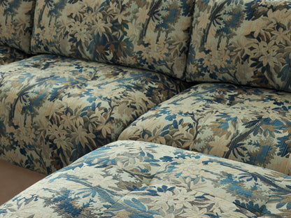Keegan Six-Piece Sectional sofa, U-shaped, upholstered in light beige fabric with blue and green botanical print, on a wooden floor.