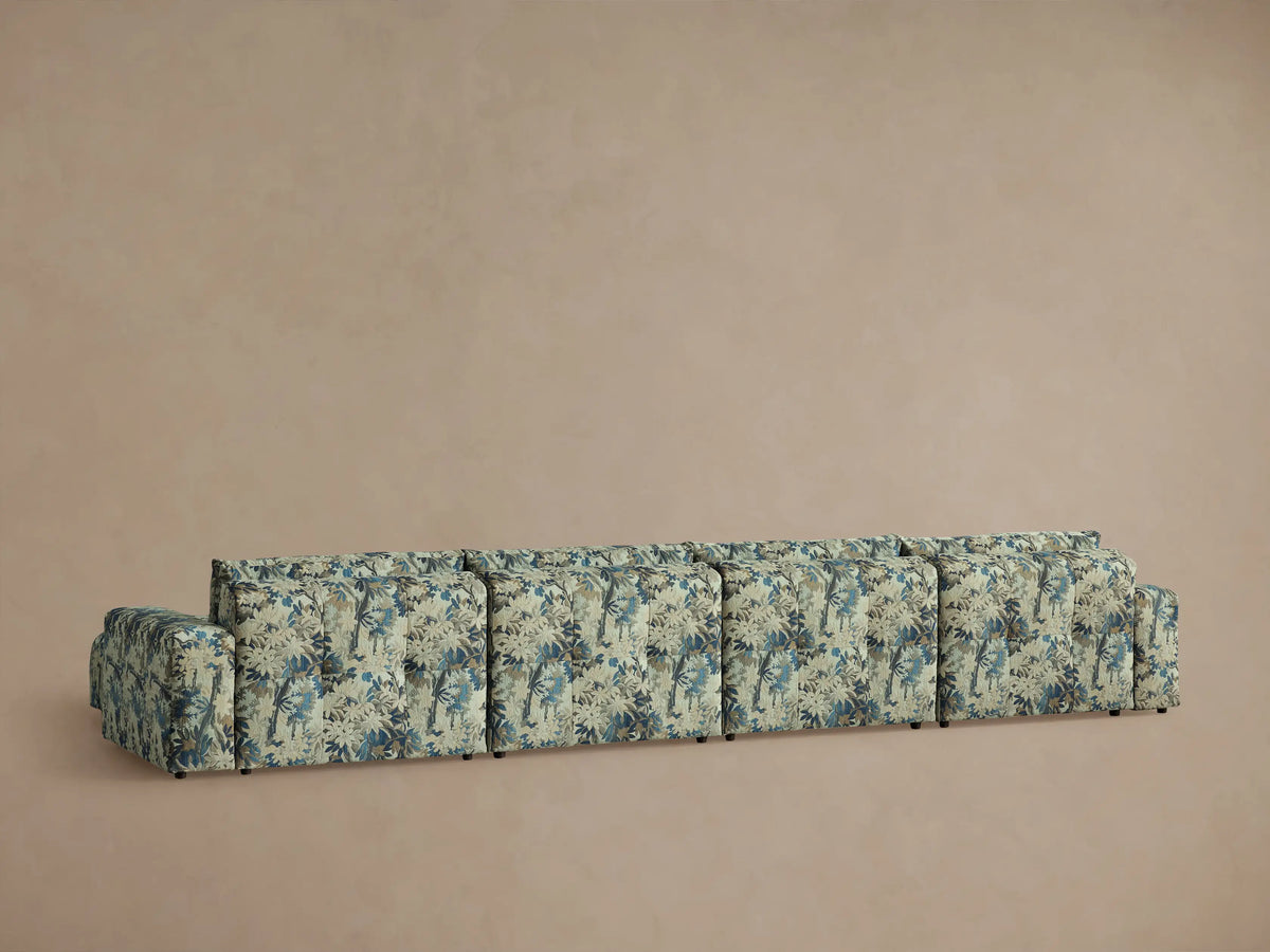 Close-up of Keegan Six-Piece Sectional's plush fabric with a detailed blue, beige, and brown botanical pattern.