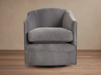 Giles Swivel Chair in dark gray fabric, featuring a curved backrest and wide seat cushion on a round base for 360-degree rotation.