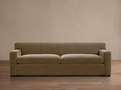 Bronte Sofa: Modern, muted olive green fabric sofa with straight lines, square arms, and dark feet on a wood floor.