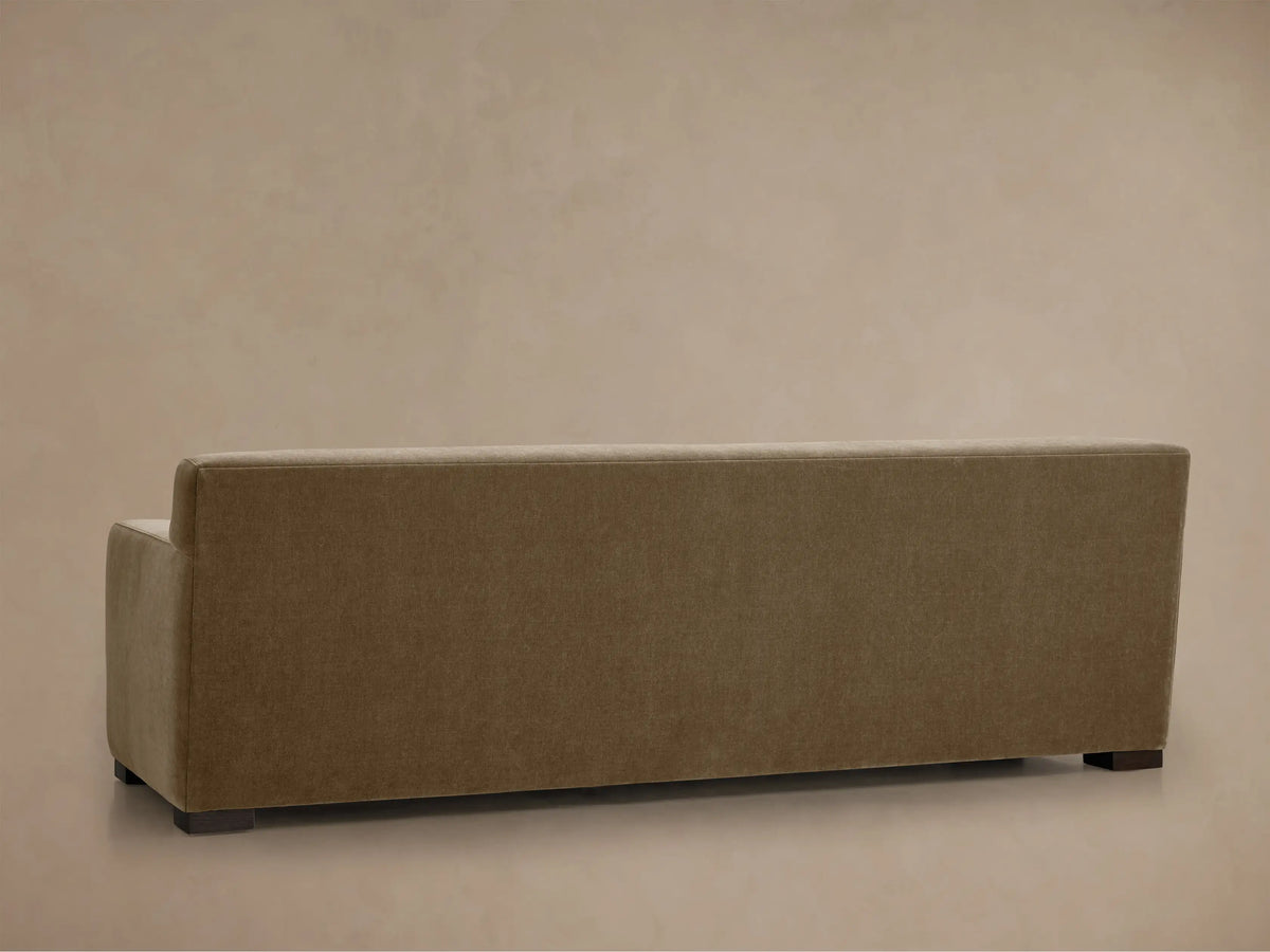 Close-up of Bronte Sofa's textured brown fabric armrest and seat, angled view showing soft, muted color and detailed stitching.
