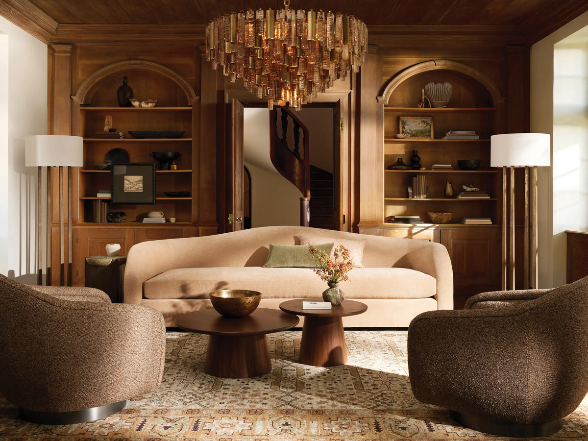 Ashbury Swivel Chair in light beige fabric, featuring a rounded back, wide arms, and a gleaming brass swivel base.