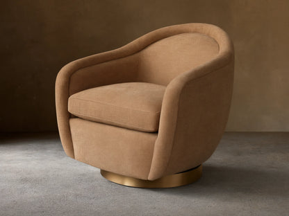 Ashbury Swivel Chair in light beige fabric, featuring a rounded back, wide arms, and a gleaming brass swivel base.