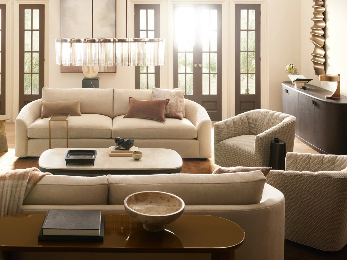 Light cream Ellison Channel-Stitched Swivel Chair, front-right view. Channel stitching on back, black swivel base on wood floor.