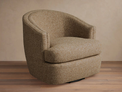 Kieran Swivel Chair with a curved backrest and cushioned seat in a textured beige fabric, placed on a wooden floor.