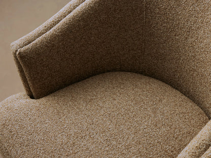 Kieran Swivel Chair in brown fabric, featuring a rounded backrest and cushioned seat, set on a wooden floor.