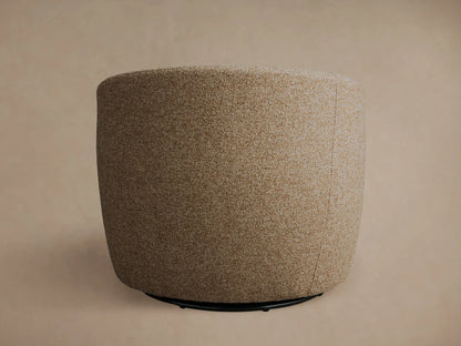 The Kieran Swivel Chair features a rounded back and is upholstered in textured beige fabric, viewed from the rear angle.