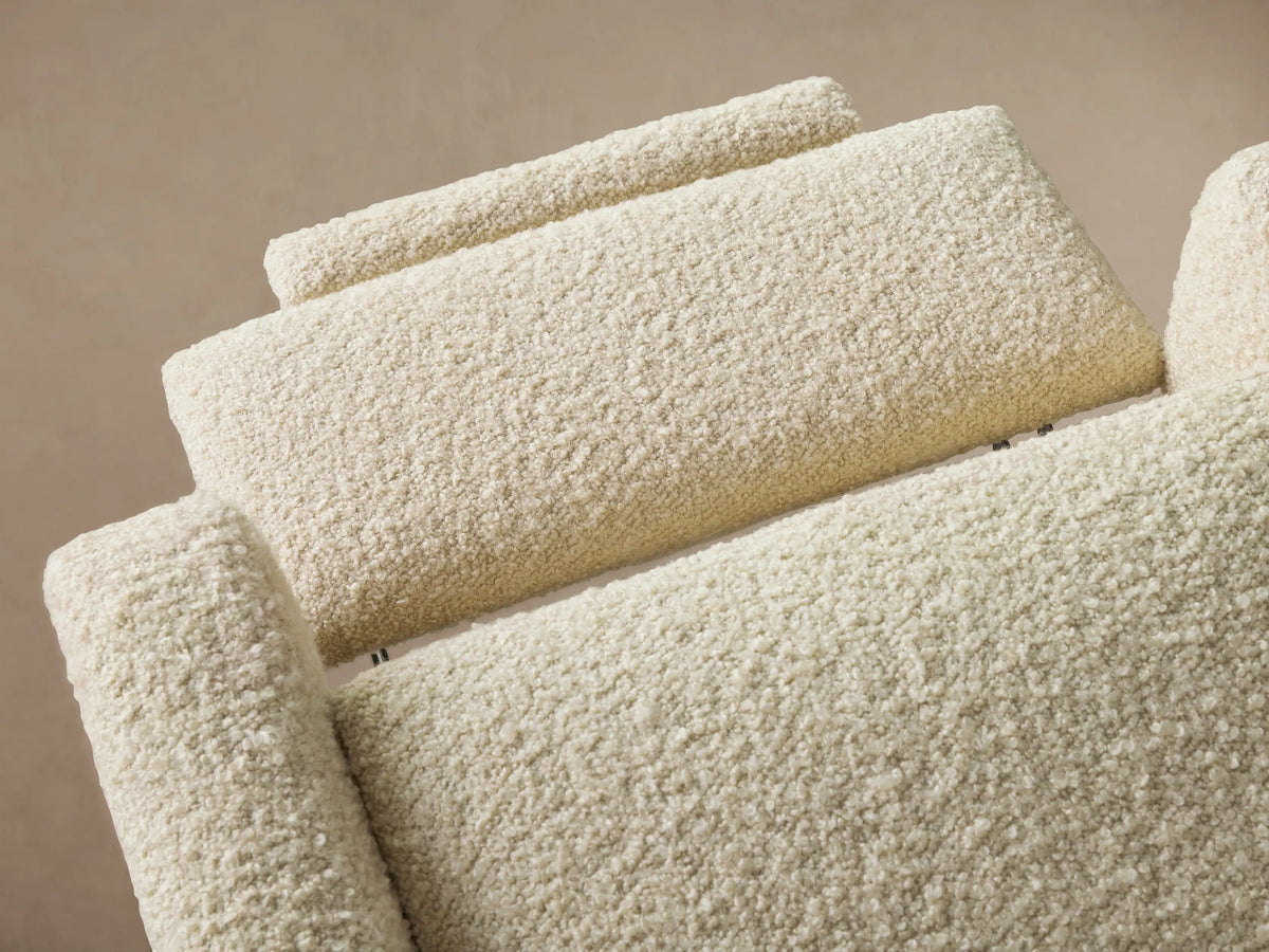 Cream Colfax Motion Recliner, upholstered in textured boucle fabric, standing upright against a neutral wall on a wood floor.