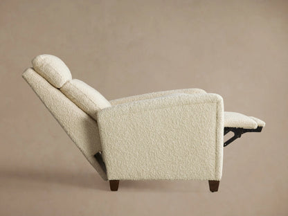 Close-up of the Colfax Motion Recliner's silver two-button motion control embedded in textured cream fabric.
