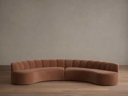 Front view of the Dusty Rose Amira Two-Piece Curved Sectional with channel tufting on the backrest.