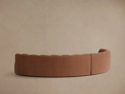 Close-up of the terra cotta velvet Amira Two-Piece Curved Sectional, showing the fluted backrest and curved seat.