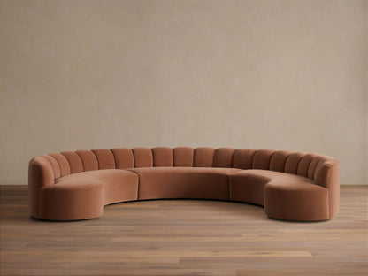 Front view of a Rust Amira Three-Piece Curved Sectional with a channeled backrest.