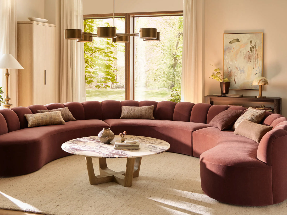 Front view of a Rust Amira Three-Piece Curved Sectional with a channeled backrest.