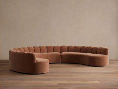Front view of the Terracotta Amira Three-Piece Curved Sectional with fluted backrests and a low profile.