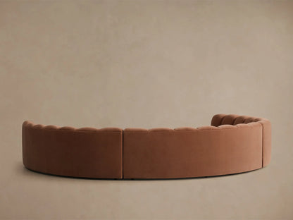 Rear view of the Rust Amira Three-Piece Curved Sectional, featuring channel tufting on the backrests.