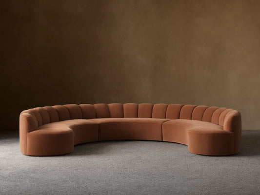 Front view of a Rust Amira Three-Piece Curved Sectional with a channeled backrest.