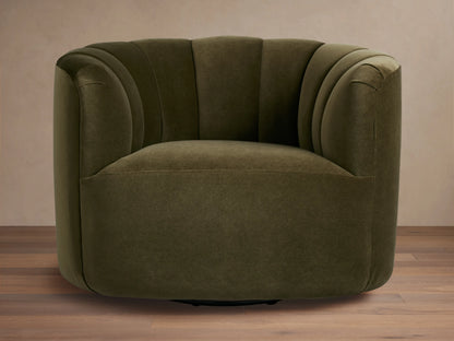 Dark olive green velvet Amira Swivel Chair, rounded form, vertical channel tufting on back, angled view on wood floor.
