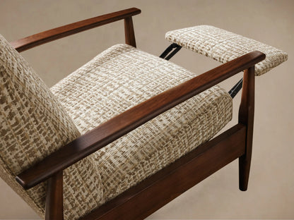 Rear and side view of a high-back lounge chair with a dark brown wooden frame, curved armrests, and beige patterned fabric upholstery.