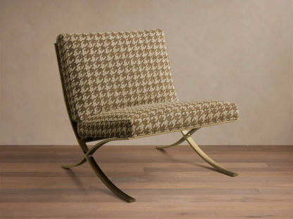 Front view of the Moxie Chair with brown and beige houndstooth upholstery and gold-toned finished stainless steel X-legs.