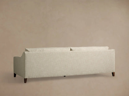 Close-up of the cream textured fabric on the Ashby Elevated Sofa, showing a seat cushion, backrest, and armrest.