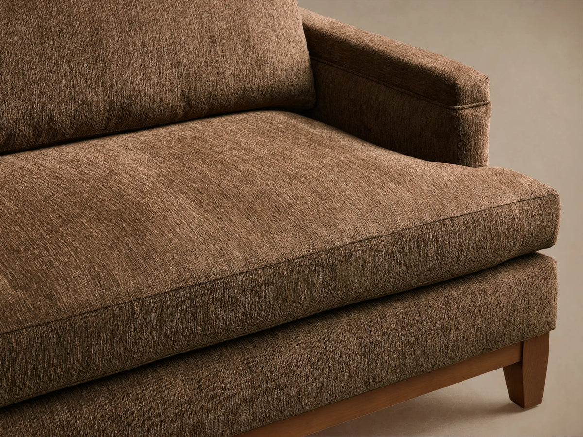 Front view of the brown textured fabric Hunter Sofa with a visible wooden base and tapered legs.