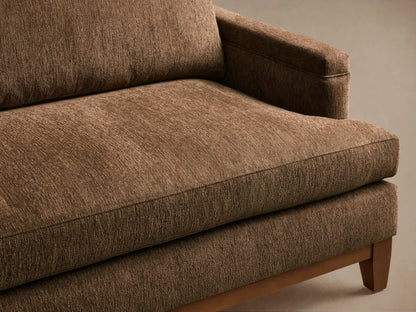 Front view of the brown textured fabric Hunter Sofa with a visible wooden base and tapered legs.