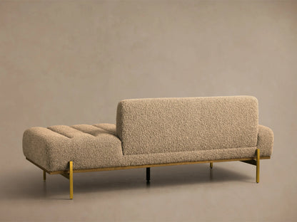 Close-up of the beige textured fabric Lansing Daybed with horizontal channel tufting, wooden base, and golden metal leg.