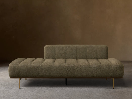 Front view of an olive green textured chaise lounge with a low back, channeled seat, and wooden base with metal legs.