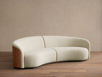Front view of the curved cream Caden Two-Piece Sectional with walnut wood veneer end panels.
