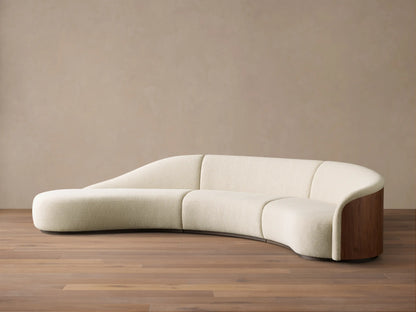 Front view of a Cream Caden Three-Piece Bumper Sectional, curved, with a left bumper and dark walnut veneer end panel.