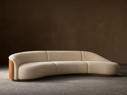 Front view of the cream Caden Three-Piece Bumper Sectional with a curved design and walnut veneer end panel.