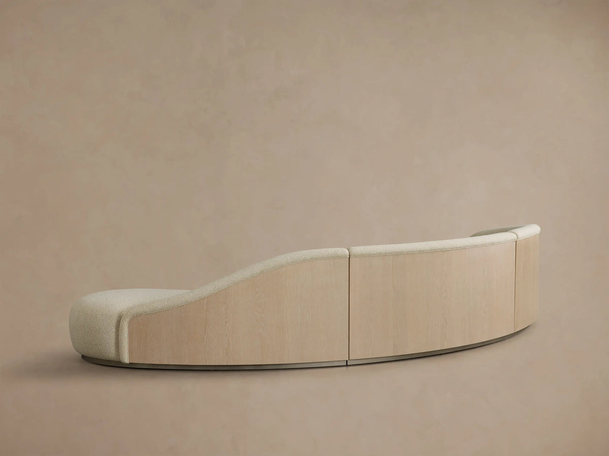 Front view of the Cream Caden Three-Piece Bumper Sectional, showcasing its curved, modular design with three connected pieces.