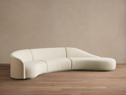 Back view of the curved beige fabric Caden Three-Piece Bumper Sectional with sand oak veneer panels.