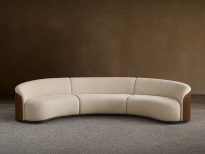 Front view of an off-white Caden Three-Piece Sectional with a curved design, upholstered in textured fabric and dark walnut veneer side panels.