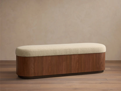Front view of the Caden Storage Bench, with an elongated light beige textured top and a walnut wood base.