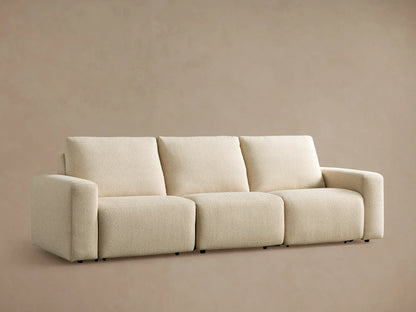 Brennan Three-Piece Motion Sofa, light cream textured fabric, modern design with blocky arms & cushions, on wood floor.