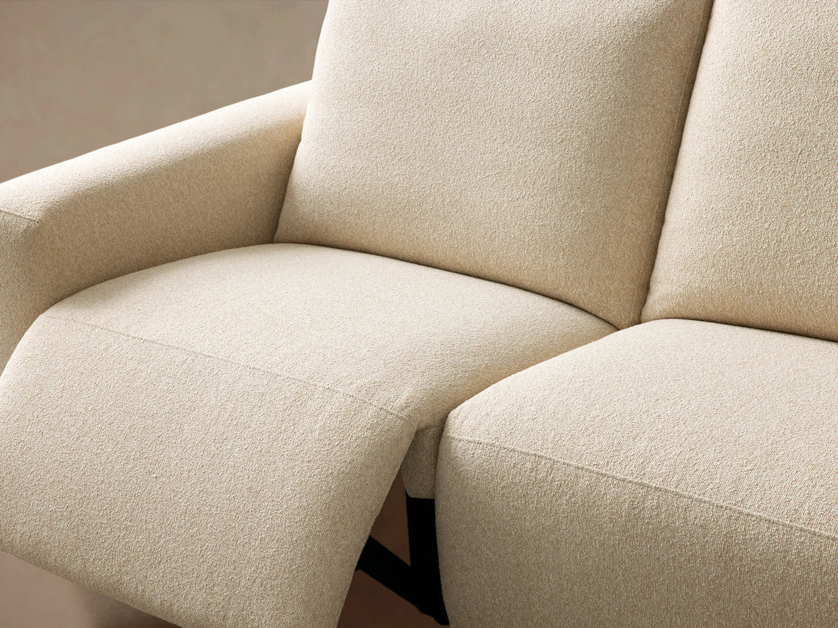 Cream Brennan Three-Piece Motion Sofa, textured fabric, modern blocky design. Three modular sections against a light beige wall.