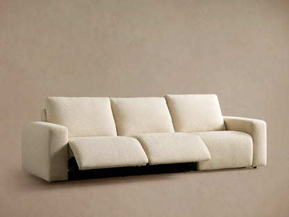 Close-up: Brennan Motion Sofa's textured cream fabric with two dark gray oval recline control buttons embedded.