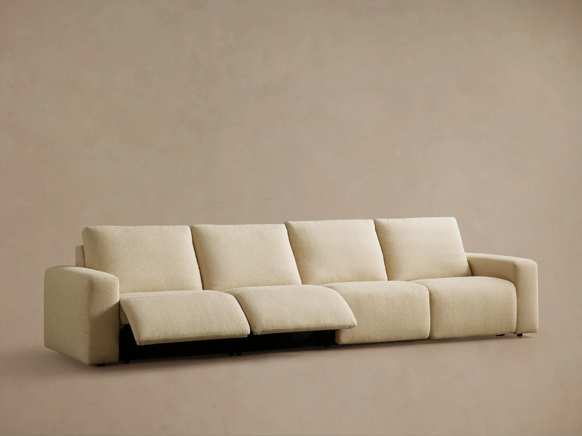 Brennan Motion Sectional: Close-up of two dark gray control buttons on light beige textured fabric, with black trim.