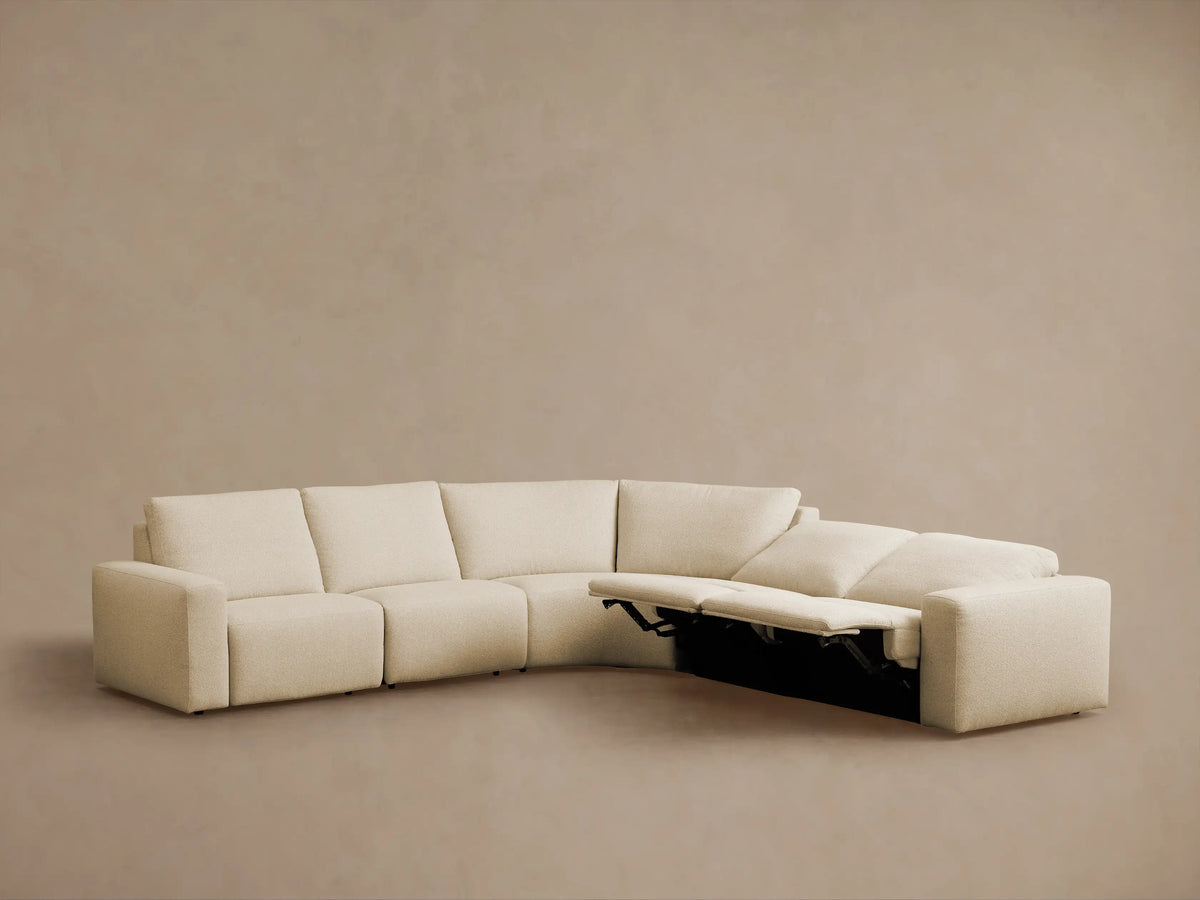 Brennan Five-Piece Motion Corner Sectional, light beige, L-shaped, left recliner extended, on a taupe background.