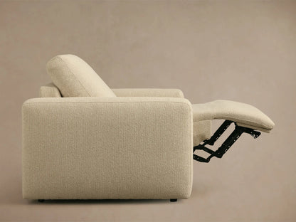 Light beige textured Brennan Motion Recliner, front quarter view, with its footrest extended, revealing black motion mechanism.