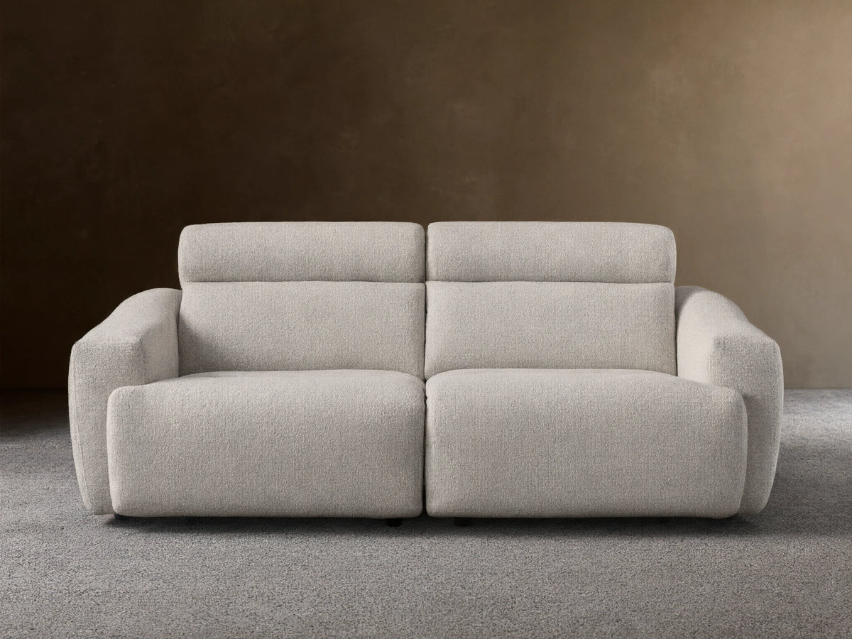 Front view of the Light beige Fia Two-Piece Motion Sofa, showing its textured bouclv© fabric and separate headrest sections.