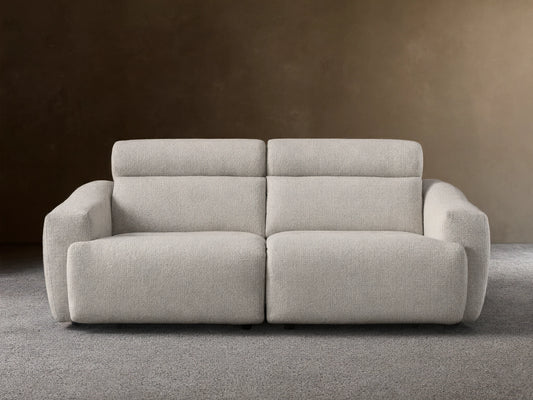 Front view of the Light beige Fia Two-Piece Motion Sofa, showing its textured bouclv© fabric and separate headrest sections.